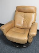 A tab leather swivel reclining armchair on wooden base