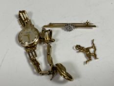 A 9ct gold and diamond bar brooch, similar archer charm and earring,