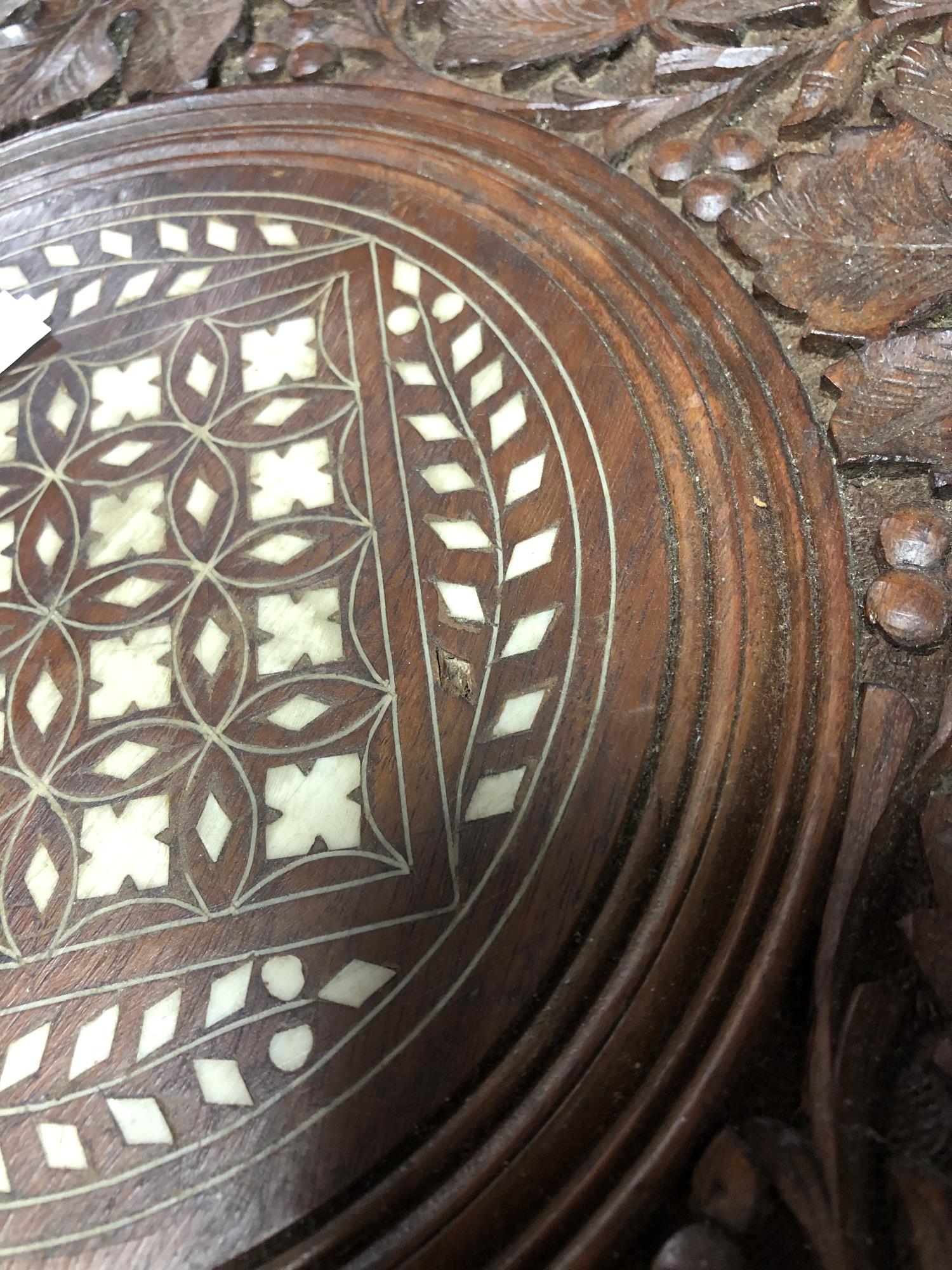 A carved folding Eastern hardwood table with bone inlay CONDITION REPORT: Small loss - Image 2 of 2