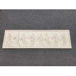 A chalk frieze panel depicting eight Roman figures holding hands