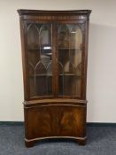 A reproduction mahogany concave corner display cabinet (locked,