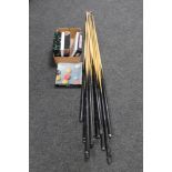 A box of ten assorted pool cues with rests,