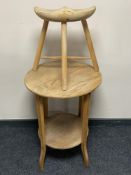 An early 20th century two tier occasional table and a milking stool