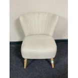 A contemporary bedroom chair in cream fabric