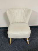 A contemporary bedroom chair in cream fabric