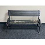 A cast iron and wooden slatted garden bench