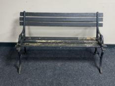 A cast iron and wooden slatted garden bench