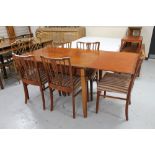 A mid 20th century extending dining table and five rail back chairs