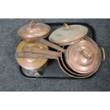 A tray of three antique copper cast iron handled pans with lids and an antique cooking pot