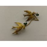 A pair of 15ct and enamel swallow brooches