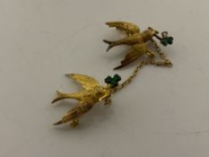 A pair of 15ct and enamel swallow brooches