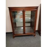 A mahogany double door display cabinet,