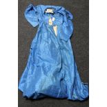A 19th century blue silk dress, with black trim to sleeves and neckline, lined, buttons missing.
