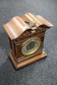 A 19th century continental mahogany mantel clock with silvered dial