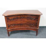An antique continental mahogany shaped front two drawer chest