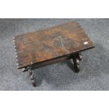 An antique carved oak cracket stool dated 1706 with carved coat of arms