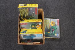 A box of four boxed Bosch power tools - two hammer drills,