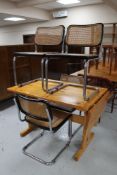 Four Italian kitchen chairs on tubular metal legs and a pine refectory dining table