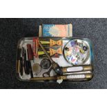 A tray of two antique brass temperature gauges, enamelled transport badges, two pocket watches,