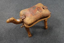 A 20th century camel stool with leather saddle