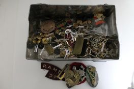 A large collection of military badges and buttons etc