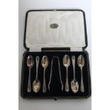 A set of six cased silver teaspoons with sugar tongs,