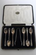 A set of six cased silver teaspoons with sugar tongs,