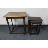 An Edwardian oak occasional table together with a nest of three oak tables