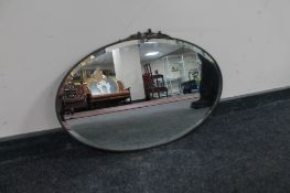 An oval framed Art Deco chrome mirror