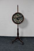 A Victorian mahogany tapestry pole screen on tripod stand