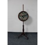 A Victorian mahogany tapestry pole screen on tripod stand