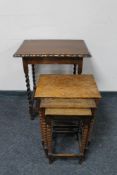 An early 20th century oak barley twist table and a nest of three oak bobbin turned tables
