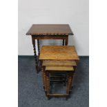 An early 20th century oak barley twist table and a nest of three oak bobbin turned tables