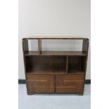 A set of walnut Art Deco bookshelves fitted cupboard beneath