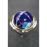 A large gemstone globe on stand