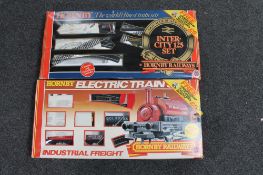 Two boxed Hornby train sets together with a further box of Hornby wagons and universal adapters