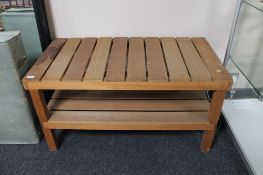 A teak slatted two tier coffee table