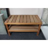 A teak slatted two tier coffee table