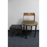 An Edwardian oak two tier wall shelf together with a folding eastern brass topped table and a mid