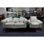 A two seater settee and armchair in cream classical print plus loose cushions