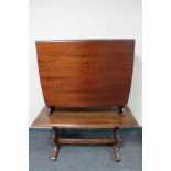 A narrow mahogany drop leaf table and an oak coffee table