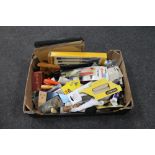 A box of new and used hand tools including wood chisels, saws,