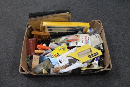 A box of new and used hand tools including wood chisels, saws,