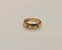 An 18ct gold ruby and diamond band ring, size K1/2. CONDITION REPORT: 4.1g.