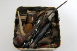 A box of antique and later pipes, carved treen pieces, figure of a man, Black Forest style bear,