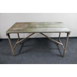A mid 20th century folding wooden trestle table