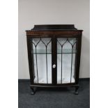 An Edwardian mahogany double door display cabinet on claw and ball feet