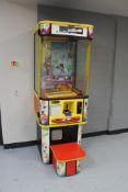 A coin operated arcade toy grabbing machine