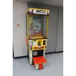 A coin operated arcade toy grabbing machine