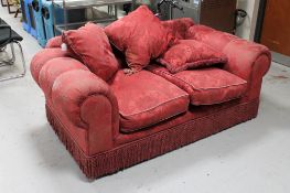 A two seater Victorian style settee in red brocade